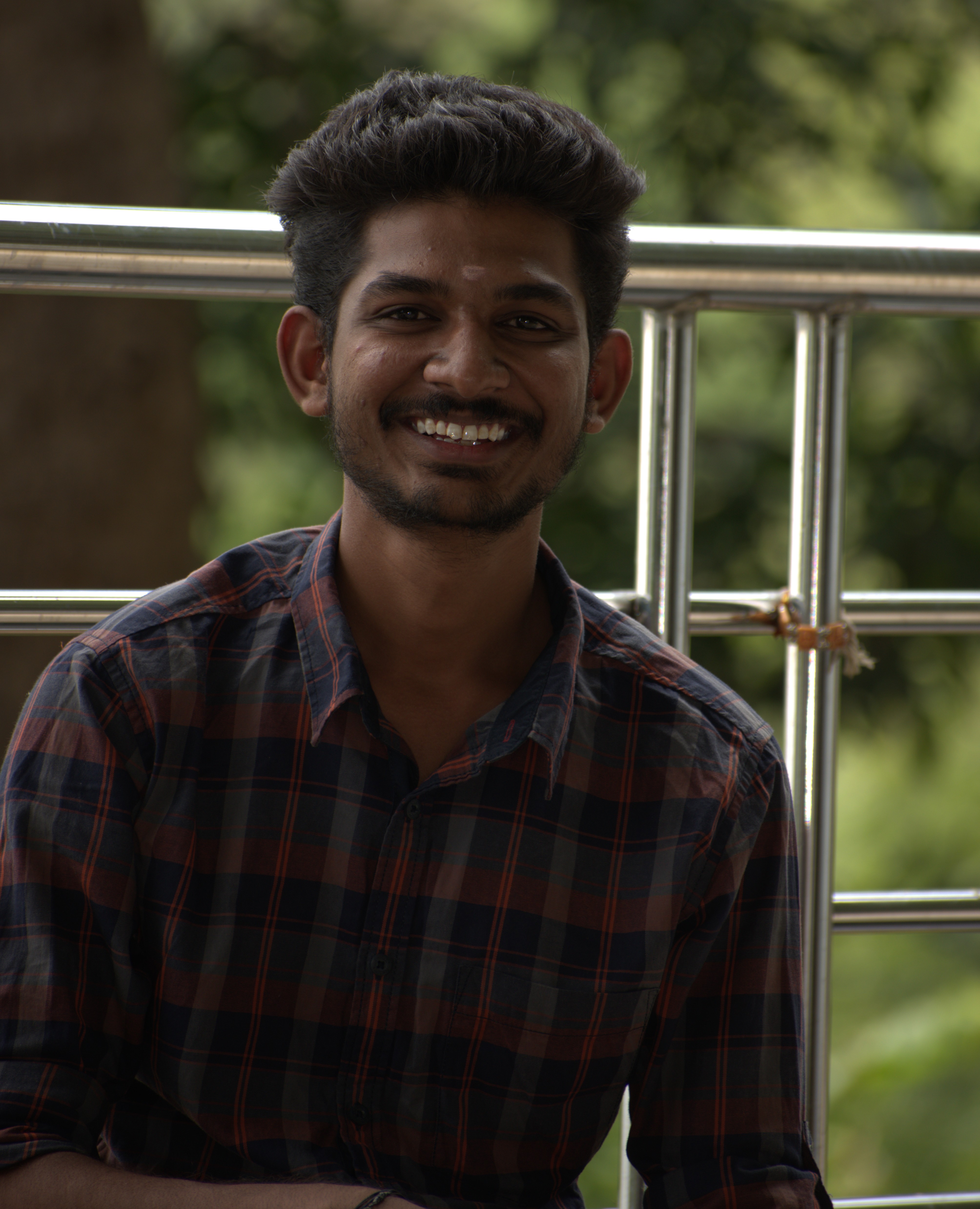 Professional developer working at a modern laptop in a bright coffee shop environment