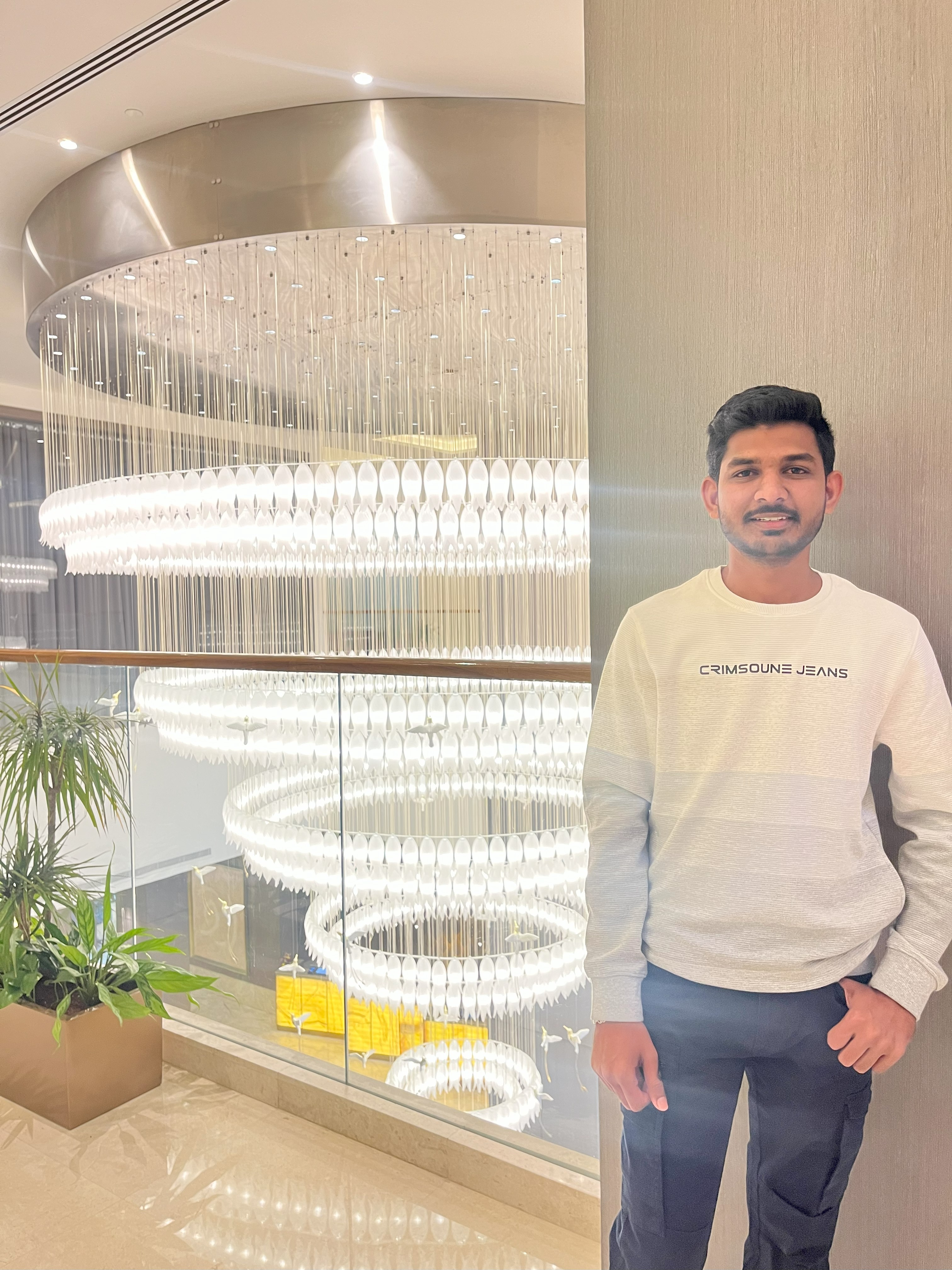 Casual portrait of developer in modern apartment with city view behind